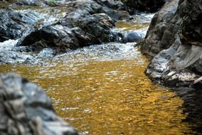 golden stream among the rocks