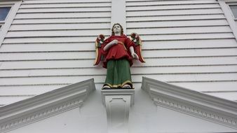 angel on the facade of a white building in norway