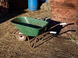 green wheelbarrow on the farm
