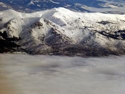 snow-capped mountains in the clouds
