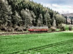 red train in countryside