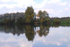reflection of trees on the surface of a pond in Russia