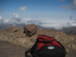 red-black backpack on top of a mountain in Morocco