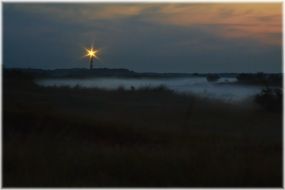 sunset fog lighthouse sea late evening