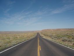 smooth, boundless asphalt road in the Arizona steppe