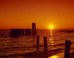 ocean sunset sea piers silhouettes