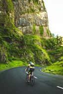 cyclist on an asphalt road in the mountains