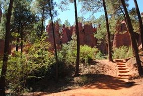 rocks of Red Ochre Natural Mineral Pigment in forest, france, roussillon