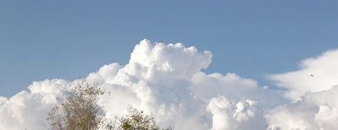 fluffy clouds in blue sky sunny scene