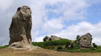 rock on a background of blue sky with clouds