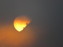 orange yellow sun on a gray sky