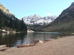 Spring view of the river near the snow-capped mountains in Colorado