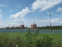 landscape of nuclear power plant and wind turbine in Finland