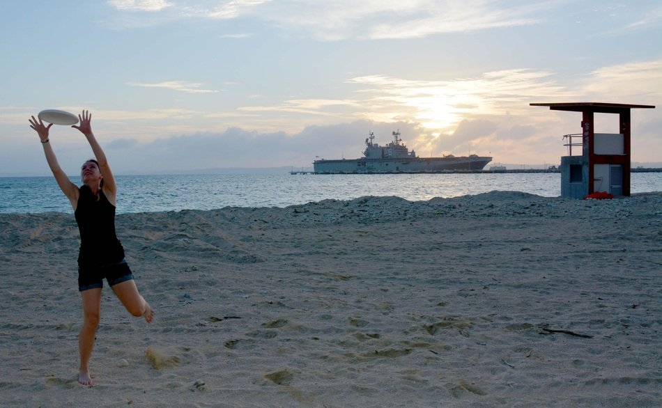 girl with frisbee on the beach