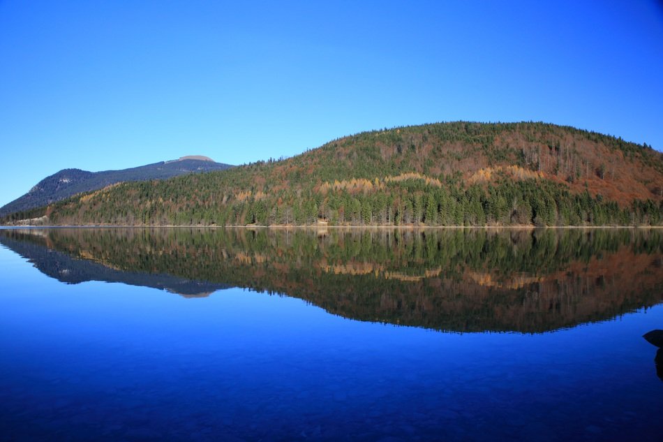 mirror image of the mountain and sky in the pond