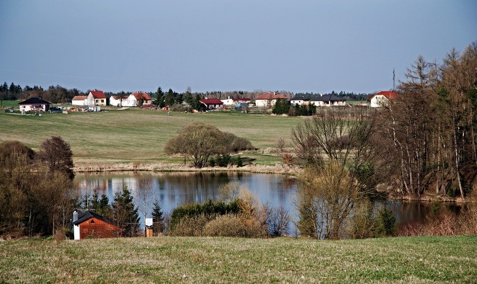 distant view of a village near a pond in southern bohemia