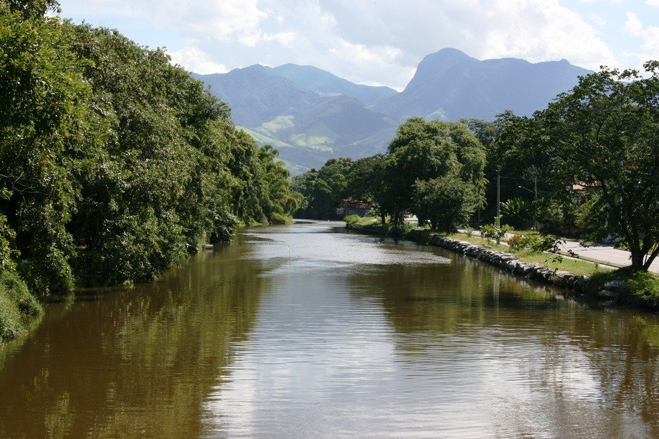 Landscape of canal with trees and mountains