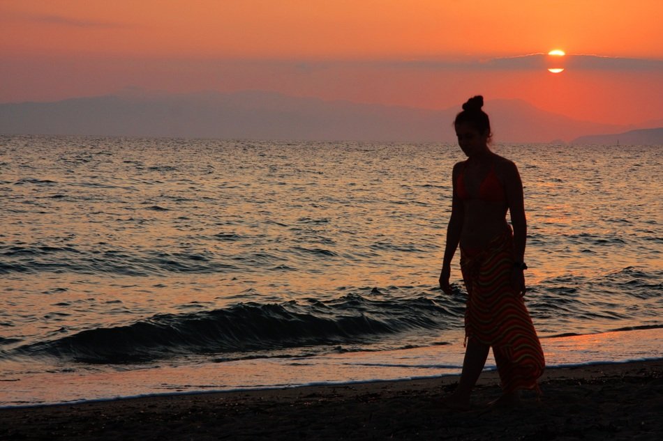 girl by the ocean at sunset