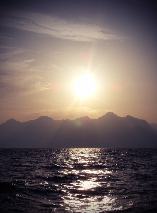sunset over mountains over water