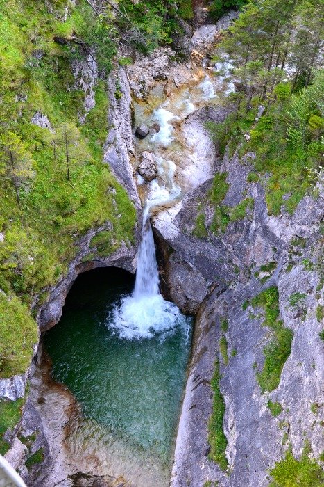 mountain waterfall flows into the pond