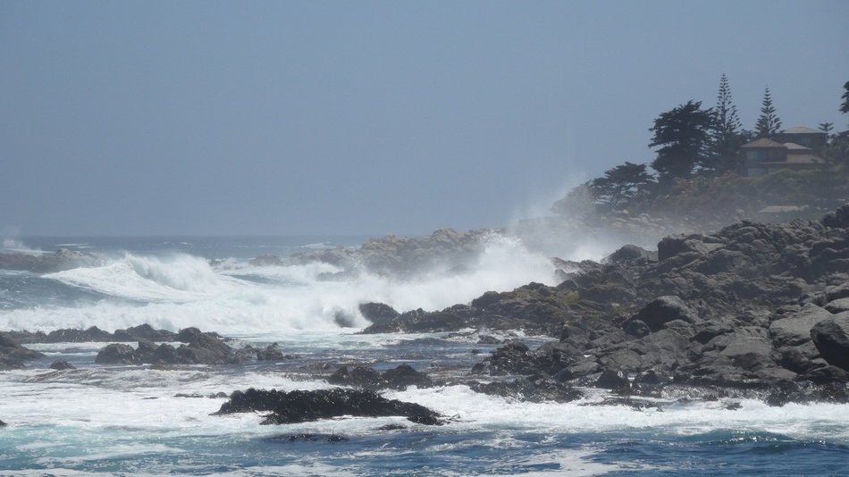 the waves beat against the rocks at the edge of the sea