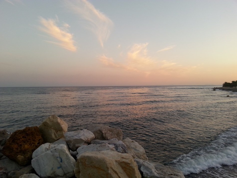 white and beige boulders by the sea