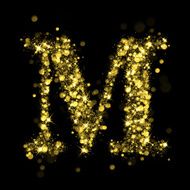 Sparkling letter M of glittering stars bokeh