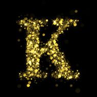 Sparkling letter K of glittering stars bokeh