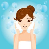 Young woman washing face with foam N2