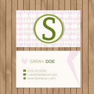 Business card with alphabet letter on a wood background N4