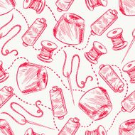 red spools of thread and needles