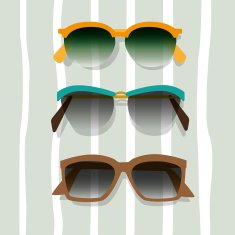 Three sunglasses placed on a beach towel