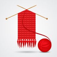 Knitted red scarf with a yarn ball