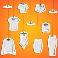 Background with stickers of modern clothes hanging on a thread