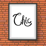 Chic Text in a White Frame Hanging on Brick Wall