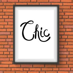 Chic Text in a White Frame Hanging on Brick Wall