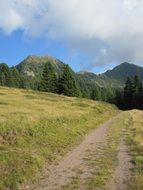 dirt road among the mountains on a sunny day