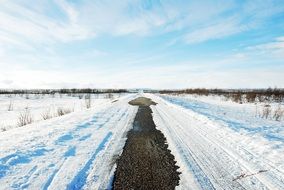 snowy long winter road in the countryside