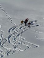 top view on the skiers with traces in deep snow