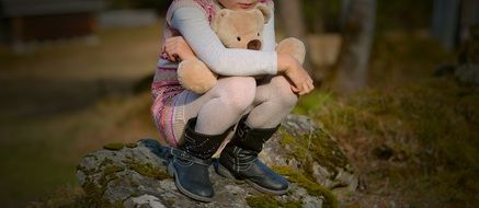 little girl squatting