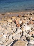 photo of Girl relaxing on a rocky beach