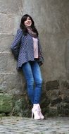 beautiful posing model near stone wall