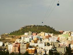 cableway with cable cars above city, saudi arabia, abha