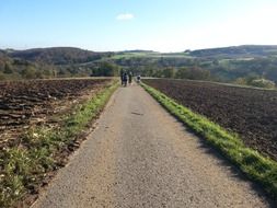 people on the road in the field