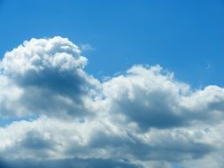 white clouds on a clear blue sky