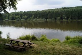 Wooden table with benches by the lake