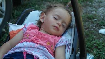 sleeping child in a child seat