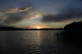 tranquil golden sunset on lake, poland, masuria