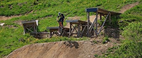 biker man jumping over the hill on a bicycle
