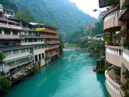 Colorful old town apartments at beautiful green-blue mountain river, Wulai, Taipei, Taiwan